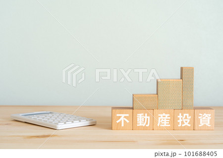 不動産投資と書かれたブロックとマンションのミニチュアと電卓 不動産投資と書かれたブロックとマンションのミニチュアと電卓 101688405