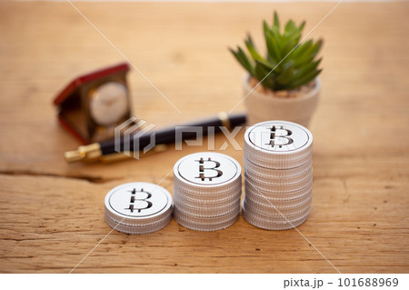 テーブルに積み上げられたお金（ビットコイン） 101688969