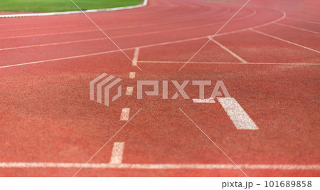 Focus number one on the running sports lane floor in the running competition field. As a background for a sports competition concept. 101689858