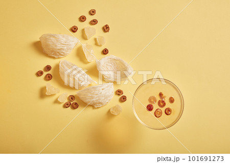 The bird nest dish gives a sweet taste with jujube, rock sugar and edible bird nest on yellow background. Healthcare food, anti-aging, strengthen the immune system 101691273