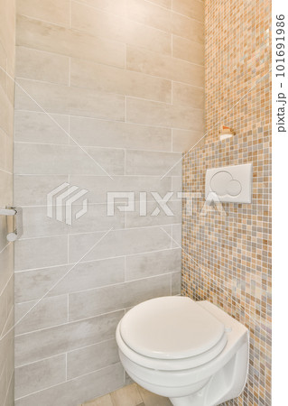 a white toilet in a bathroom with tile on the wall and tiled flooring around the toilet is next to a shower stall a white toilet in a bathroom with tile on the wall and tiled flooring around the toilet is next to a shower stall 101691986