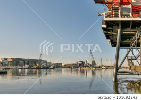 a boat in the water with buildings in the background and blue sky overcasted by some boats on the water a boat in the water with buildings in the background and blue sky overcasted by some boats on the water 101692343