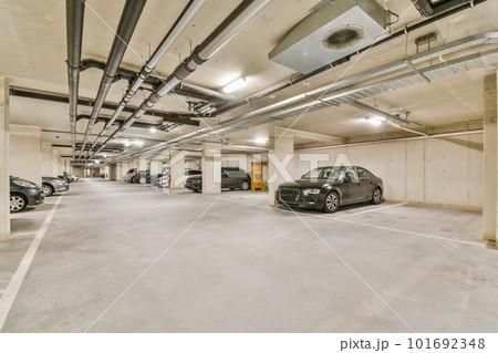 an underground parking area with cars parked in the space and no one on the ground to see how it's going an underground parking area with cars parked in the space and no one on the ground to see how it's going 101692348