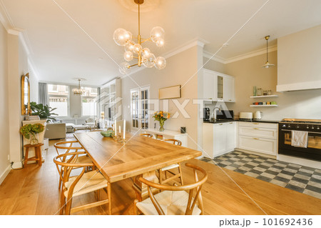 a kitchen and dining area in a house with wood floors, white cabinets, black and white checkered flooring a kitchen and dining area in a house with wood floors, white cabinets, black and white checkered flooring 101692436