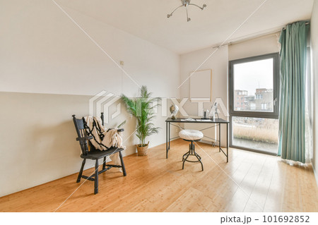 Workplace with a globe on the table next to the window and a view of the city 101692852