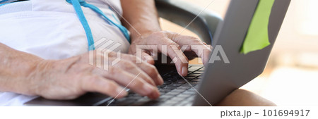 Old woman working or searching information on modern laptop Old woman working or searching information on modern laptop 101694917