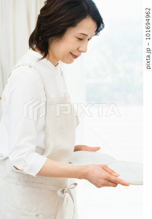 皿を片付けるミドル女性 101694962