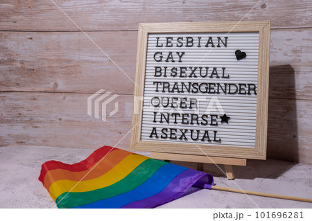 LGBTQIA description frame on Rainbow LGBTQIA flag made from silk material. LESBIAN, GAY, BISEXUAL, TRANSGENDER, QUEER, INTERSEX, ASEXUAL Symbol of LGBTQ pride month. Equal rights. Peace and freedom LGBTQIA description frame on Rainbow LGBTQIA flag made from silk material. LESBIAN, GAY, BISEXUAL, TRANSGENDER, QUEER, INTERSEX, ASEXUAL Symbol of LGBTQ pride month. Equal rights. Peace and freedom 101696281