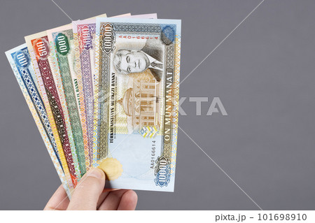 Old Turkmen money in the hand on a gray background 101698910