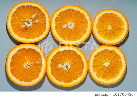 Round slices of orange on a gray background 101700456