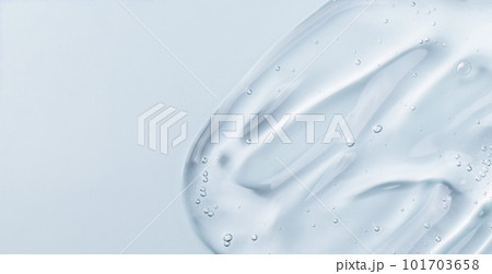 Serum gel smear on blue background. Cosmetic transparent gel serum texture. 101703658