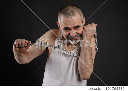 Mentally ill man gnaws a chain Mentally ill man gnaws a chain 101704581