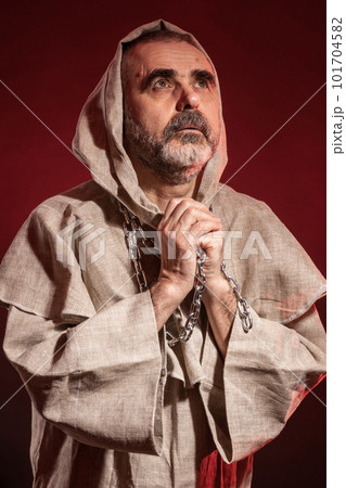 A wandering monk with a chain around his neck seeking the eternal verities 101704582