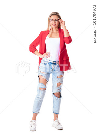 Full length portrait of young woman wearing glasses, red jacket and ripped jeans. Isolation on a white background 101704972