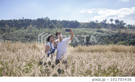 Snapping selfies of asian couple with mobile phone 101705436