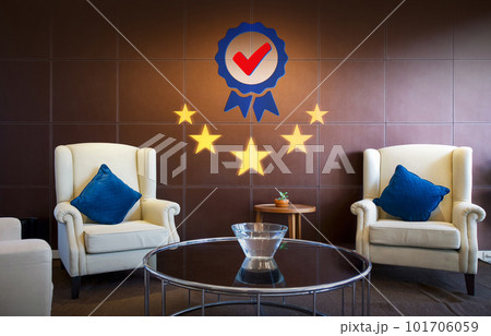 Brown leather panel with modern round tempered glass table and cream armchair, shows the sign of top service Quality assurance 5 star, Guarantee, ISO certification and standardization concept 101706059