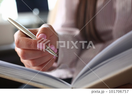 Woman writes with pen in notebook in office or at home 101706757