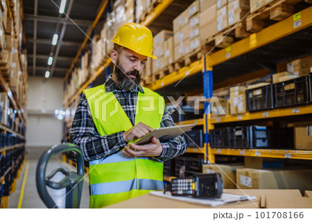 Warehouse worker stocking goods in a warehouse. 101708166