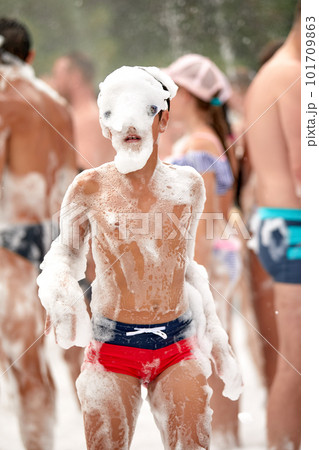 Face of a child in foam enthusiastic joyful child at a foam party, close-up of a child among the foam, baby foam party. Face of a child in foam enthusiastic joyful child at a foam party, close-up of a child among the foam, baby foam party. 101709863