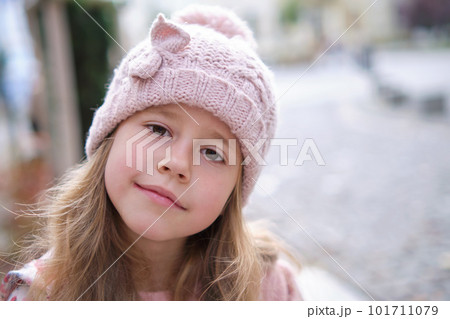 Portrait of cute little child girl in pink hat 101711079