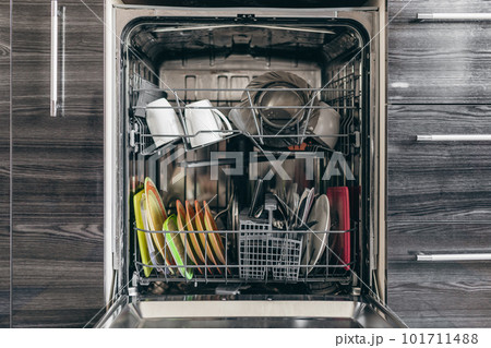 Open dishwasher with dishes built into the kitchen Open dishwasher with dishes built into the kitchen 101711488