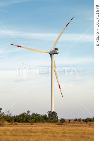 Wind energy. Wind power. Sustainable, renewable energy. Wind turbines generate electricity. Windmill farm on mountain with sunset sky. Green technology. Renewable resource. Sustainable development. Wind energy. Wind power. Sustainable, renewable energy. Wind turbines generate electricity. Windmill farm on mountain with sunset sky. Green technology. Renewable resource. Sustainable development. 101711679