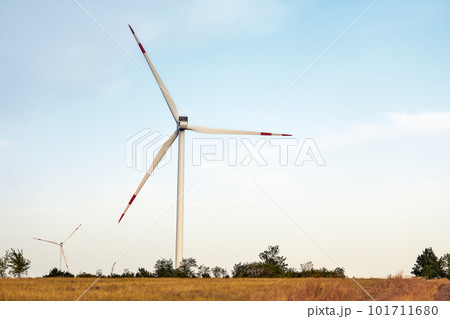 Wind energy. Wind power. Sustainable, renewable energy. Wind turbines generate electricity. Windmill farm on mountain with sunset sky. Green technology. Renewable resource. Sustainable development. Wind energy. Wind power. Sustainable, renewable energy. Wind turbines generate electricity. Windmill farm on mountain with sunset sky. Green technology. Renewable resource. Sustainable development. 101711680
