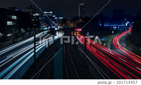 Long exposure - light traces of cars on the A40 freeway in Essen, Germany. German Autobahn at night Long exposure - light traces of cars on the A40 freeway in Essen, Germany. German Autobahn at night 101713457