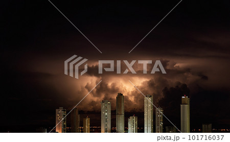 Orange storm clouds over city skyline at dusk Orange storm clouds over city skyline at dusk 101716037