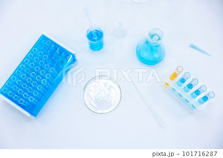 Chemistry experiment, science laboratory, flasks and test tubes contain different chemicals. 101716287
