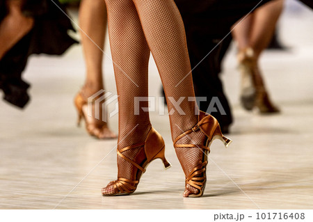 female dancer on his toes, close-up legs in dancing shoes and fishnet black stockings 101716408