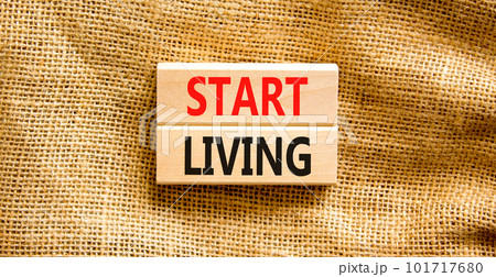 Start living symbol. Concept words Start living on beautiful wooden block. Beautiful canvas table canvas background. Business and Start living concept. Copy space. 101717680