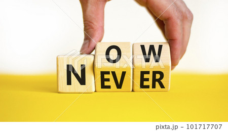 Now or never symbol. Businessman turns wooden cubes and changes the concept word Never to Nowa. Beautiful yellow table white background, copy space. Business and now or never planning concept. 101717707