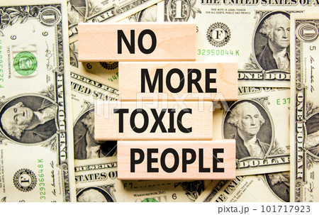 No more toxic people symbol. Concept words No more toxic people on wooden blocks on a beautiful background from dollar bills. Business, psychological no more toxic people concept. 101717923