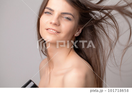 Beautiful long haired woman drying hair in bathroom 101718658
