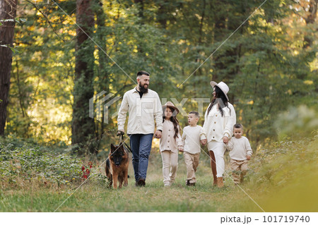 Happy playful family runing in park with pet. Young mom, dad having fun with three kids and big dog outdoors. Parents with children holding hands. Active lifestyle parenthood concept. Happy childhood Happy playful family runing in park with pet. Young mom, dad having fun with three kids and big dog outdoors. Parents with children holding hands. Active lifestyle parenthood concept. Happy childhood 101719740