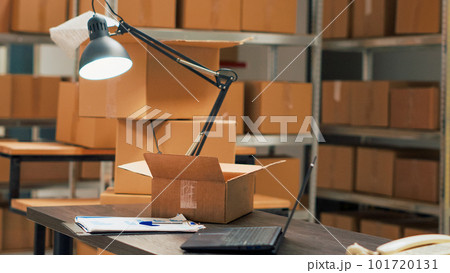 Warehouse filled with racks and shelves to put cardboard boxes, preparing packages with merchandise and products for shipping. Empty storage room space used as small business. Handheld shot. Warehouse filled with racks and shelves to put cardboard boxes, preparing packages with merchandise and products for shipping. Empty storage room space used as small business. Handheld shot. 101720131