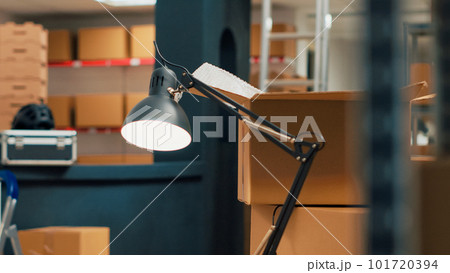 Storage room filled with cardboard boxes on shelves and racks, empty warehouse used to ship merchandise order to clients. Storehouse space with products, distribution work. Handheld shot. Storage room filled with cardboard boxes on shelves and racks, empty warehouse used to ship merchandise order to clients. Storehouse space with products, distribution work. Handheld shot. 101720394