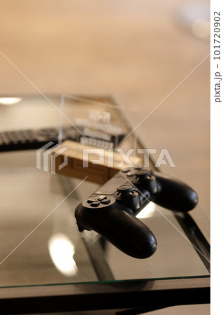 video game controller on glass table. gaming, technology and entertainment concept - blue gamepad controller on table video game controller on glass table. gaming, technology and entertainment concept - blue gamepad controller on table 101720902