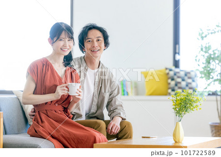 リビングでくつろぐ若い男女 リビングでくつろぐ若い男女 101722589