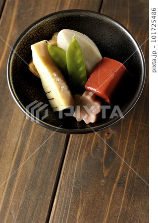 筍や里芋、生麩、サヤエンドウ等が入っている煮物を俯瞰で撮影 101725486