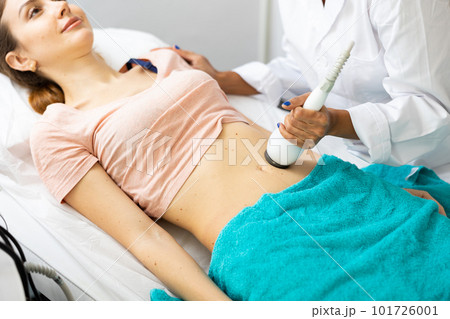 Woman having cavitation procedure Woman having cavitation procedure 101726001