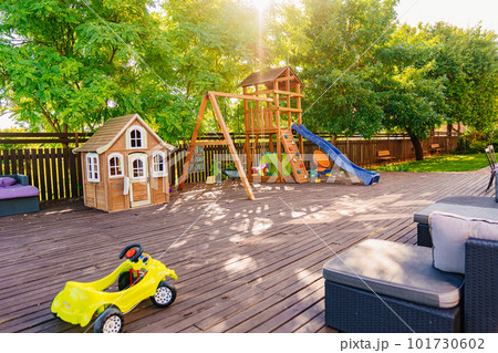 Children's playground on a wooden terrace near a country house or a summer hotel 101730602