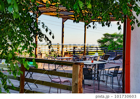 Wooden terrace with tables for outdoor dining. a dining room. 101730603