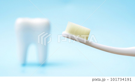 Toothbrush and tooth on a blue background. 101734191