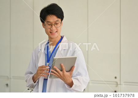 Photo of doctor in a white uniform using digital tablet in medical office. Healthcare and medical concept 101737978