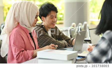 University students collaborating on a project in campus. Education, Learning and technology concept 101738003