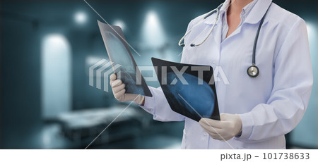 The doctor examines x-rays in the  room. 101738633