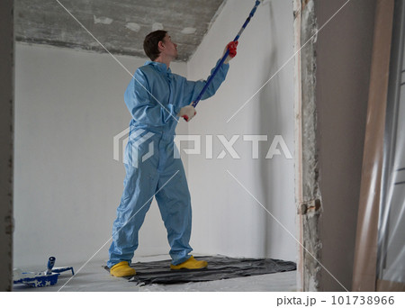 Man paints the ceiling with a roller Man paints the ceiling with a roller 101738966