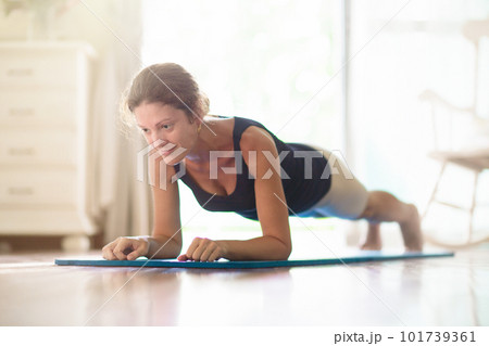Yoga exercise at home. Fit woman stretching on mat Yoga exercise at home. Fit woman stretching on mat 101739361